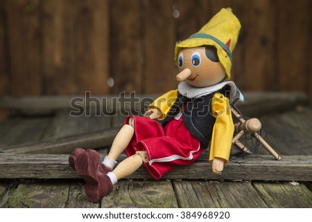 Old wooden marionette toy. Royalty-Free Stock Photo #384968920