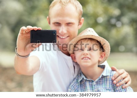 Father with son take self photo 