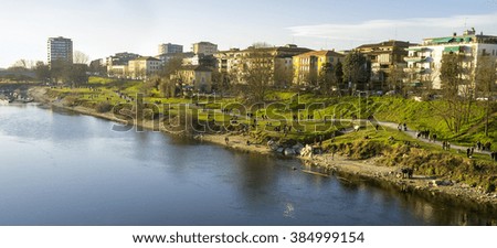 Winter view of the shores of the Ticino river, flowing through Pavia (Lombardy, Northern Italy), formerly known as the city of the hundred towers. Color image.