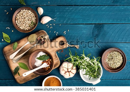 culinary background with spices on wooden table Royalty-Free Stock Photo #385031401