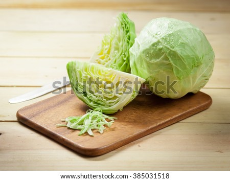 cabbage and cutted cabbage on wooden Royalty-Free Stock Photo #385031518