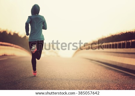 young fitness woman runner athlete running at road Royalty-Free Stock Photo #385057642