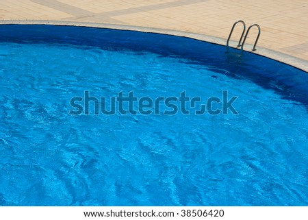 An image of blue swimming pool in summer