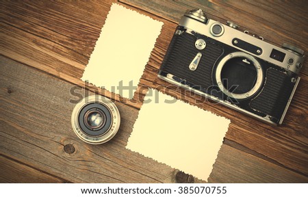 retro photo mock up, vintage camera and lens on old wooden background. still life with copy space. instagram image filter retro style