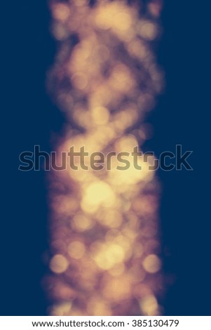 Beautiful gold glowing bokeh in the middle of vertical background.