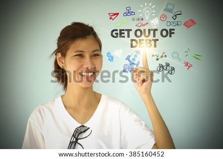 young woman smiling and hand pointing at GET OUT OF DEBT concept , business concept , business idea 
