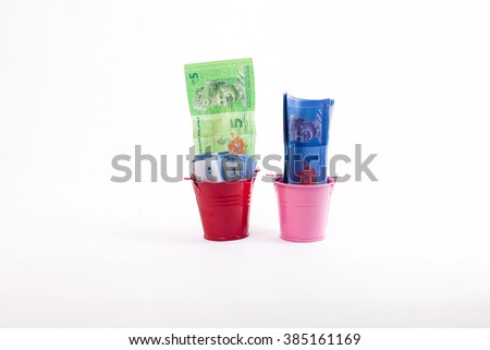 money in mini iron bucket with white background