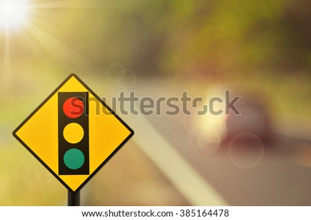 Traffic light sign on blur car country road abstract background.Retro color style.