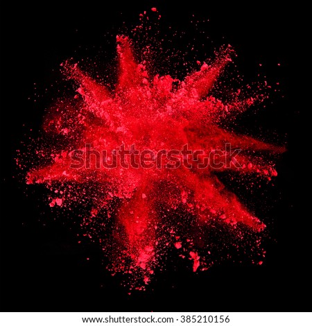 Explosion of red powder on black background Royalty-Free Stock Photo #385210156