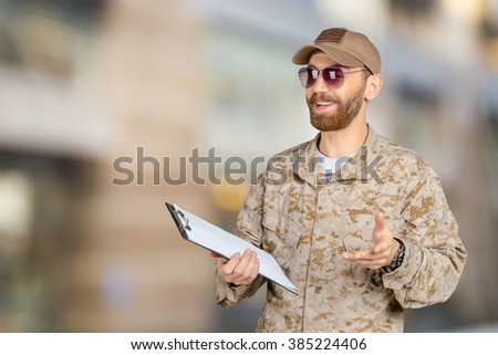 Portrait of young army soldier with a clipboard