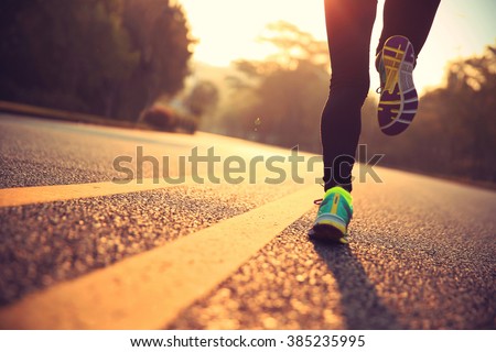young fitness woman runner athlete running at road Royalty-Free Stock Photo #385235995