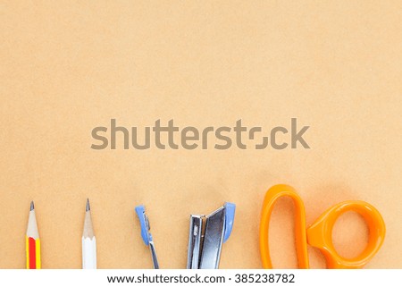 office tools placed on brown paper background in top view, Leave a space for copy