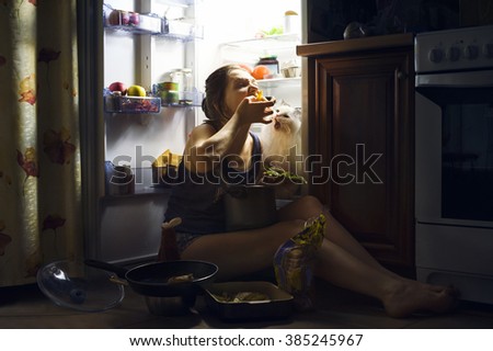 young girl and her fluffy cat eating at night Royalty-Free Stock Photo #385245967