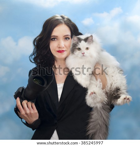 Business woman photographer and her cat on a background of the spring sky