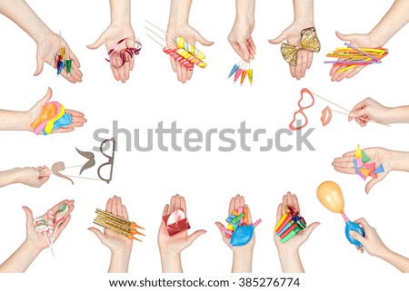 collection of party and celebration elements in a hands isolated on white background