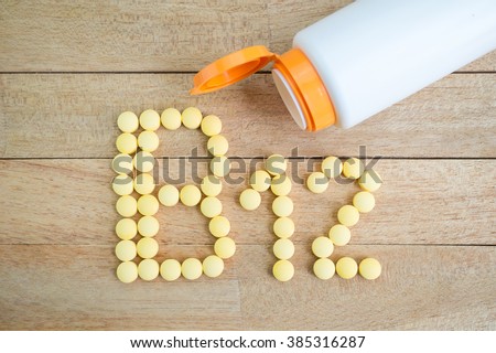 Yellow pills forming shape to B12 alphabet on wood background
 Royalty-Free Stock Photo #385316287