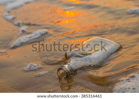 bottle on the beach at sunset time