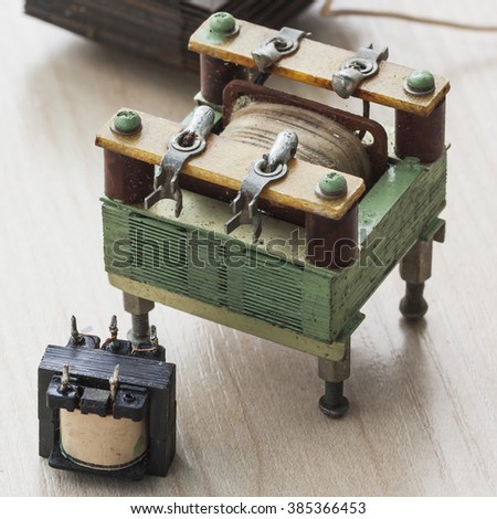 Old electrical transformers on a wooden surface