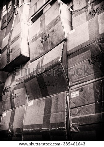 rack stack arrangement of vintage cardboard boxes in a store warehouse, toned photo