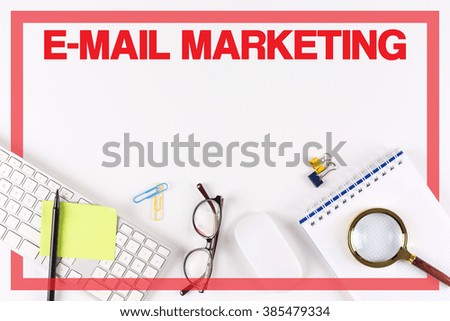 High Angle View of Various Office Supplies on Desk with a word E-MAIL MARKETING