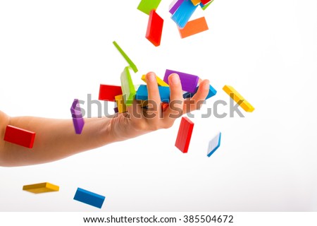 Falling colorful domino onto a  hand