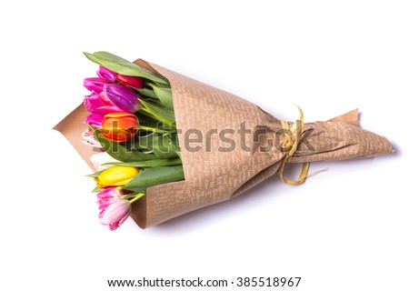 Bouquet of spring tulips with different color flowers wrapped in paper for present  isolated on white background Royalty-Free Stock Photo #385518967