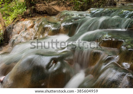 Flow of hot mineral waterfall in morning with nobody