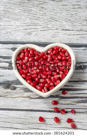  pomegranate seeds in a heart shape bowl
