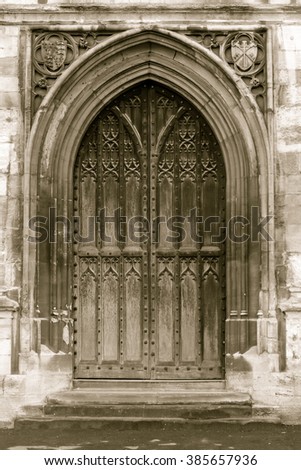 Old arched door in sepia tone