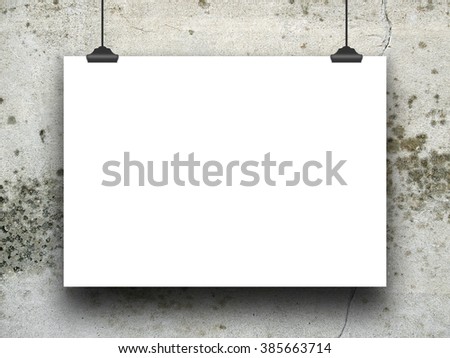 Close-up of one hanged poster paper sheet frames with clips on grey stained concrete wall background