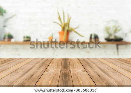Wooden board empty table in front of blurred background. Perspective brown wood over blur in coffee shop - can be used for display or montage your products.Mock up for display of product.