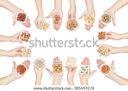 collection of nuts and seeds in a hands isolated on white background