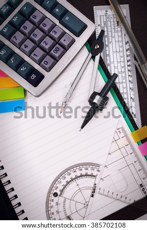 Office table desk or school supplies on table. School and office tools on office table. Desk with notebook or paper note and stationery object on office desk. Office desk concept. Math supplies.