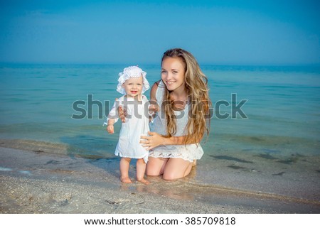 Happy family. Mother and her daughter having fun on the beach. Positive human emotions, feelings.