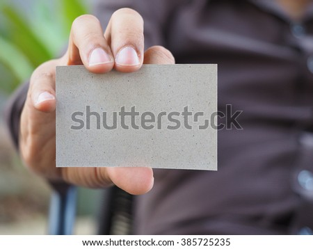 Business man sit on seat and showing is card selective focus