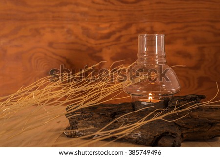 Lamps lit on the timber. With twigs white Placed on a wooden table And background