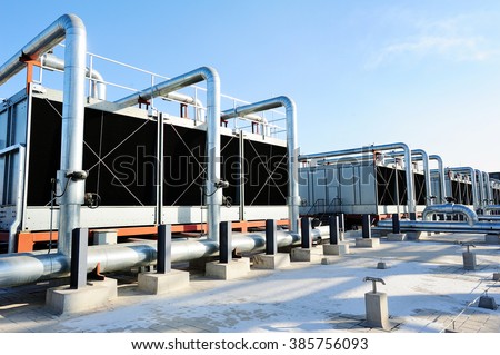 Sets of cooling towers in data center building. Royalty-Free Stock Photo #385756093