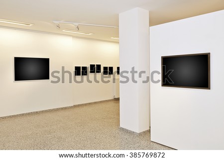 exhibition gallery, wall mounted art with museum style lighting, the art has been removed and replaced. There are path for the frame