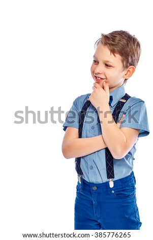 Young thinking boy in stylish blue clothes. Isolated on a white background.