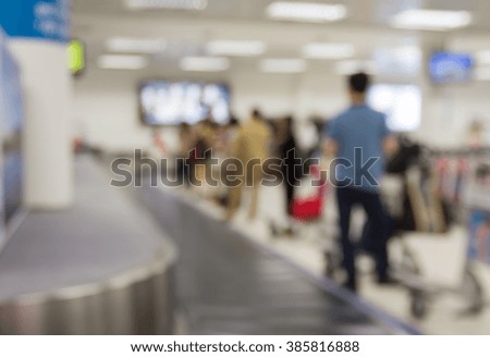 Blur passenger waiting luggage on conveyor belt in airport terminal