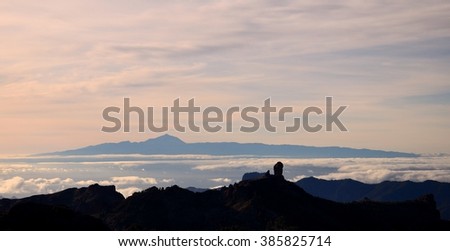 Sunset from the summit of Gran canaria, Roque Nublo in foreground and Tenerife island in background, Canary islands