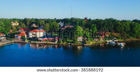 Beautiful super wide-angle panoramic aerial view of Stockholm archipelago, Sweden with harbor and skyline with scenery beyond the city, seen from the ferry, sunny summer day with blue sky Royalty-Free Stock Photo #385888192