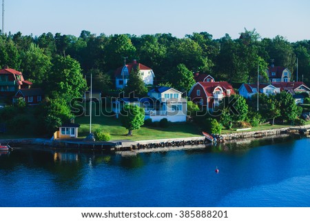 Beautiful super wide-angle panoramic aerial view of Stockholm archipelago, Sweden with harbor and skyline with scenery beyond the city, seen from the ferry, sunny summer day with blue sky Royalty-Free Stock Photo #385888201
