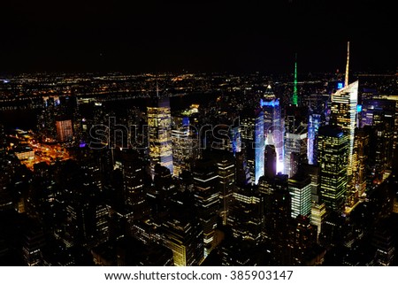 New York City Manhattan panorama aerial night view at with office building skyscrapers skyline illuminated. The New York City downtown panorama in the night.