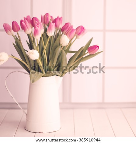 Pink tulips over white wood table 