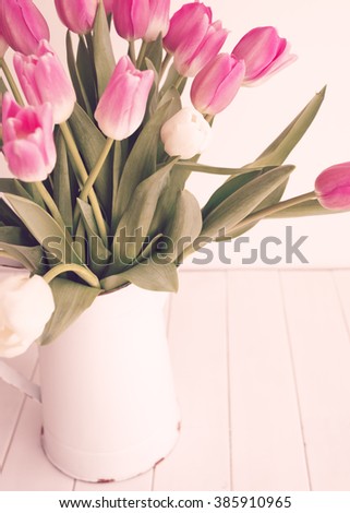 Pink tulips over white wood table 