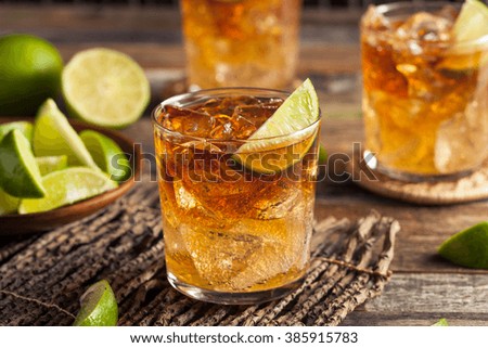 Dark and Stormy Rum Cocktail with Lime and Ginger Beer Royalty-Free Stock Photo #385915783