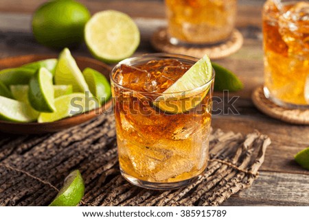 Dark and Stormy Rum Cocktail with Lime and Ginger Beer Royalty-Free Stock Photo #385915789