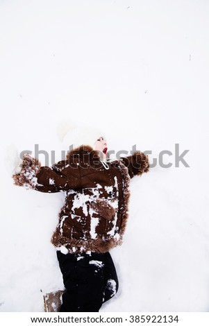 photo of Happy child baby girl in snow outdoors in winter