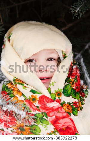 photo of portrait of small slavic girl in national scarf